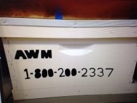 Example of identified hive. Identified hive with "AWM 1-800-200-2337" printed on side.