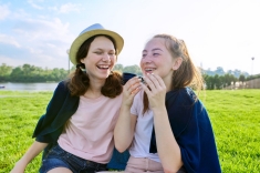 Two young girls laughing outside Two young girls laughing outside