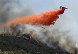 plane flying over wildfire